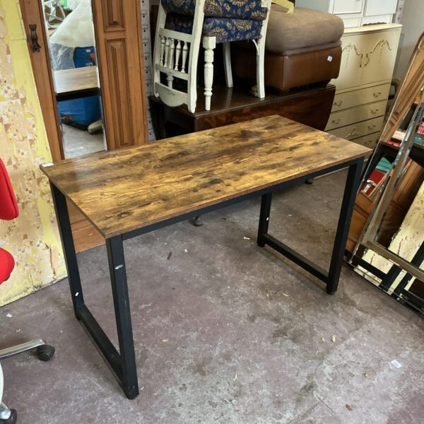 Rustic wooden display table with black metal legs.