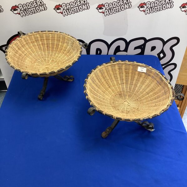 Pair of vintage wicker baskets with metal stands for display.