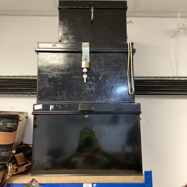 Vintage metal file box with locking mechanism for document storage.