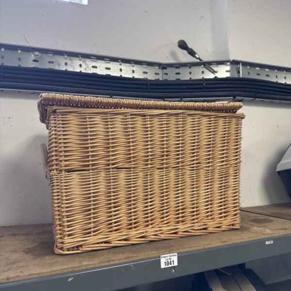 Traditional wicker hamper basket for storage and rustic decor.
