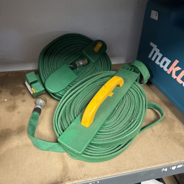 Green garden hosepipe pair for outdoor watering and garden maintenance.