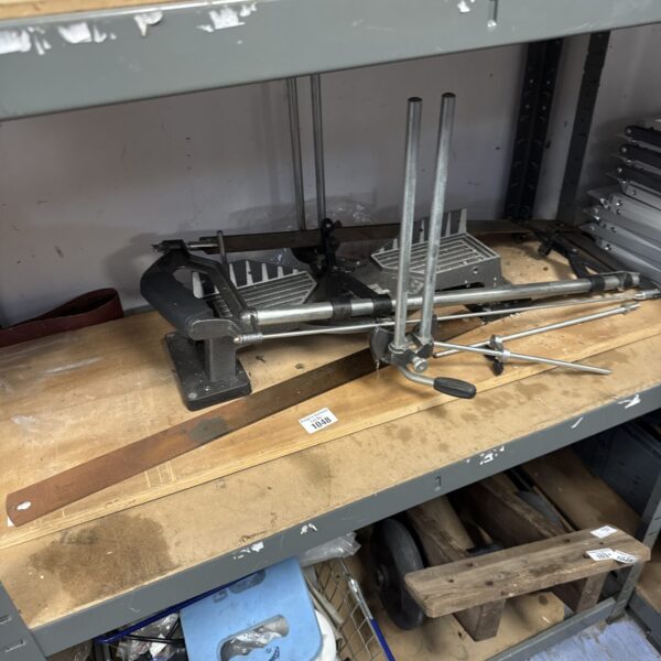 Vintage forge steel mitre saw mounted on wooden board.