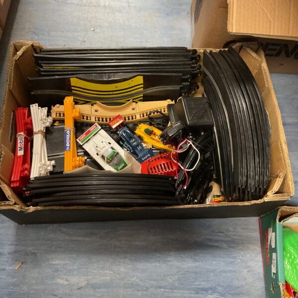 Scalextric track set with cars and various track pieces.