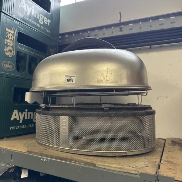 Stainless steel Cobb portable barbecue grill for outdoor cooking.