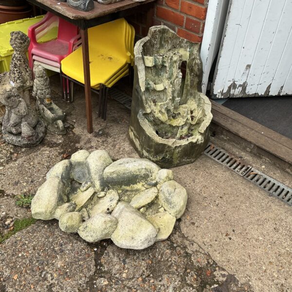 Tiered garden water feature with stone effect in outdoor setting.
