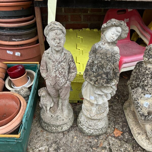 Pair of stone effect garden ornaments in an outdoor setting.