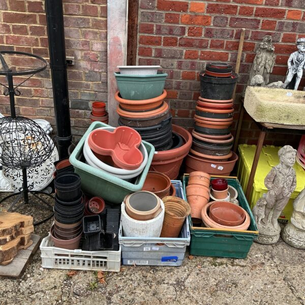 Mixed lot of terracotta and plastic garden pots and planters for sale.
