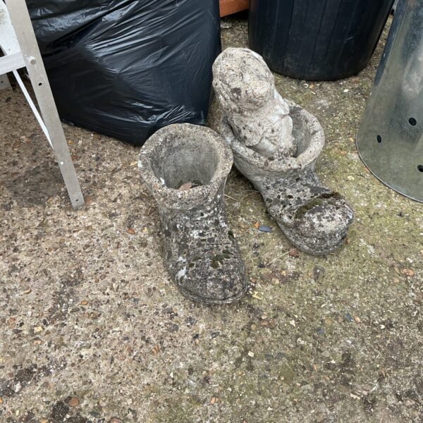 Lot of three weathered stone garden boot ornaments for garden decoration.