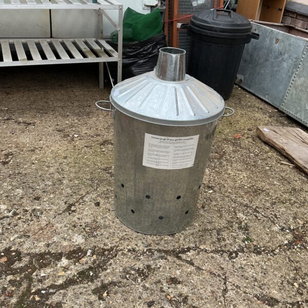 Galvanised garden incinerator for burning waste in the garden.