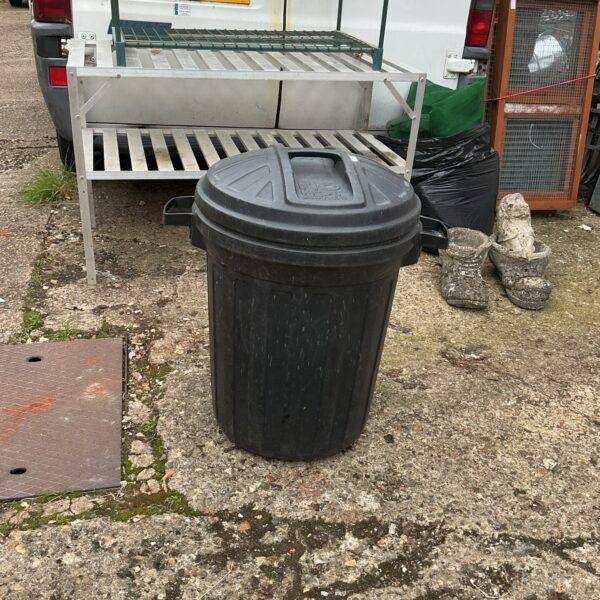 Black plastic garden waste bin for outdoor garden refuse.