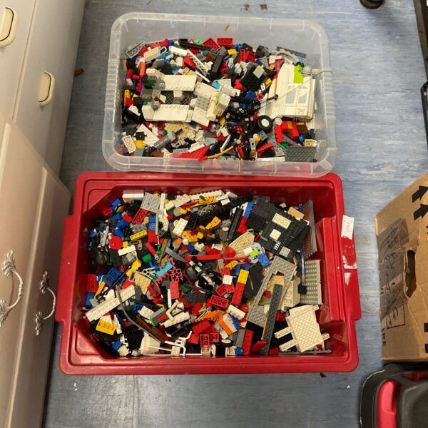 Two boxes filled with a large mixed Lego brick collection.