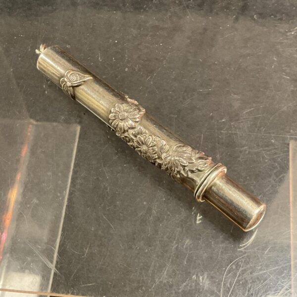 Antique Art Nouveau pencil holder with floral design.