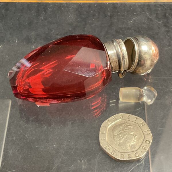Antique ruby glass scent bottle with sterling silver top.