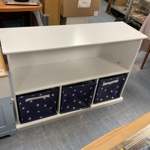 White childrens bookcase with three fabric bins for toy storage.