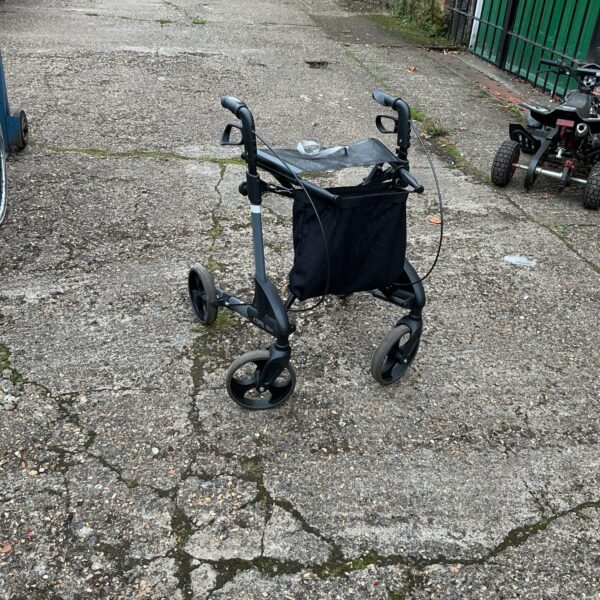 Silver walking aid trolley with shopping basket for mobility assistance.