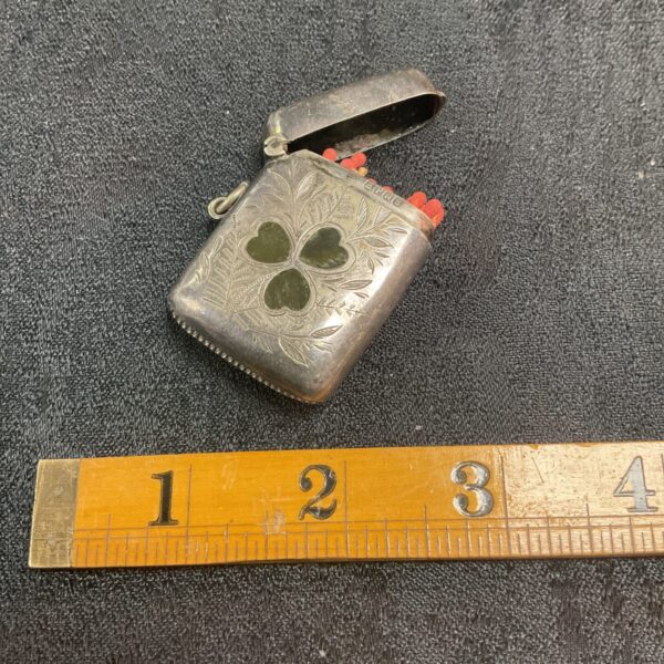 Antique silver plate vesta case with embossed floral design.