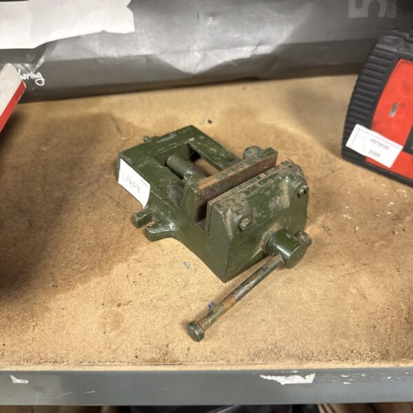 Vintage bench clamp, a small metalworkers tool with green paint.