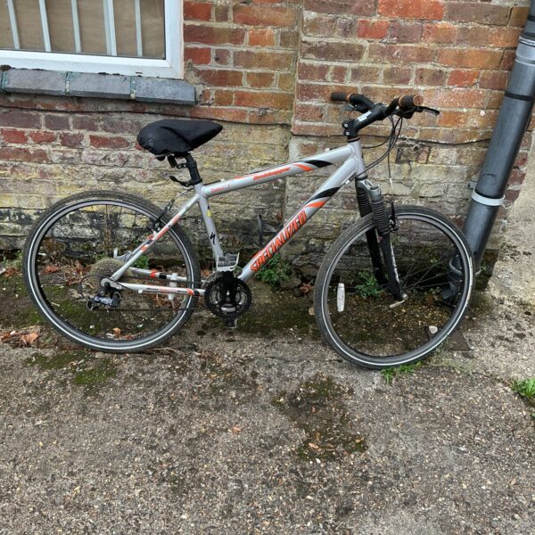 Side view of a used Specialized Rockhopper mountain bike.