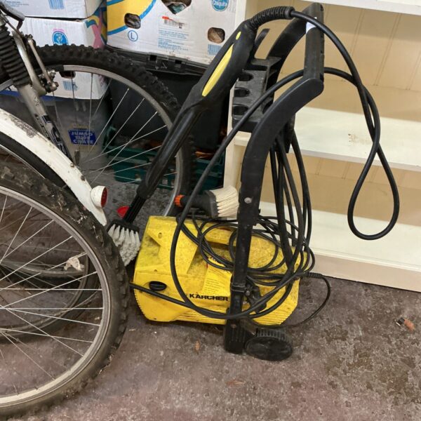 Front view of a used Karcher power washer for garden cleaning.