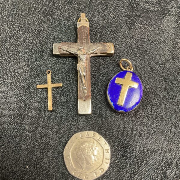Vintage crucifix pendant lot featuring detailed metal cross.