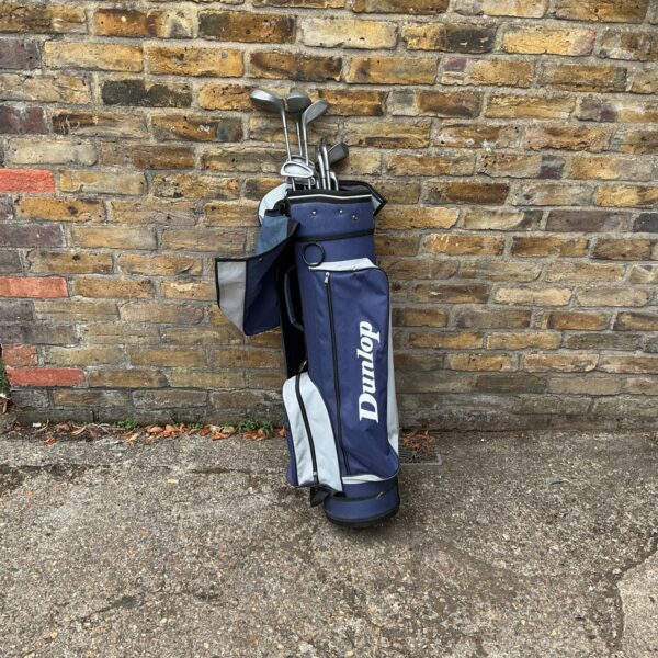 Blue Dunlop golf bag with Wilson golf clubs.