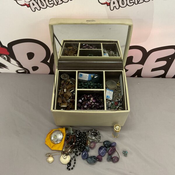 Vintage leather jewellery box filled with stone and beaded necklaces.