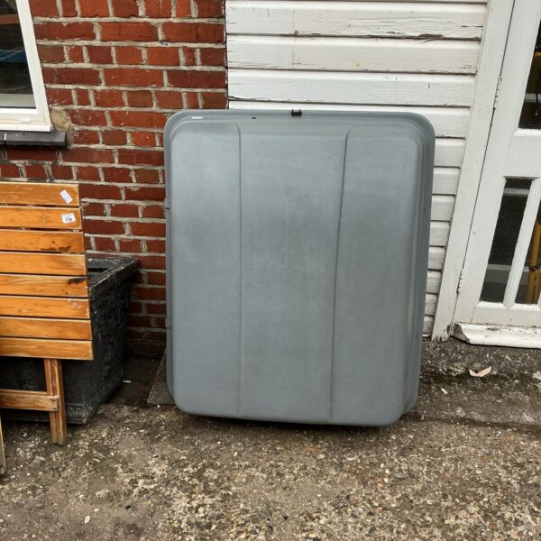 Black car top box for roof luggage storage.