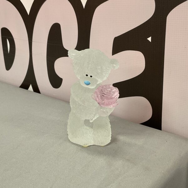 Crystal Me to You teddy bear holding a pink rose.