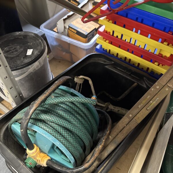 Vintage tool lot with hose reel and spirit levels.