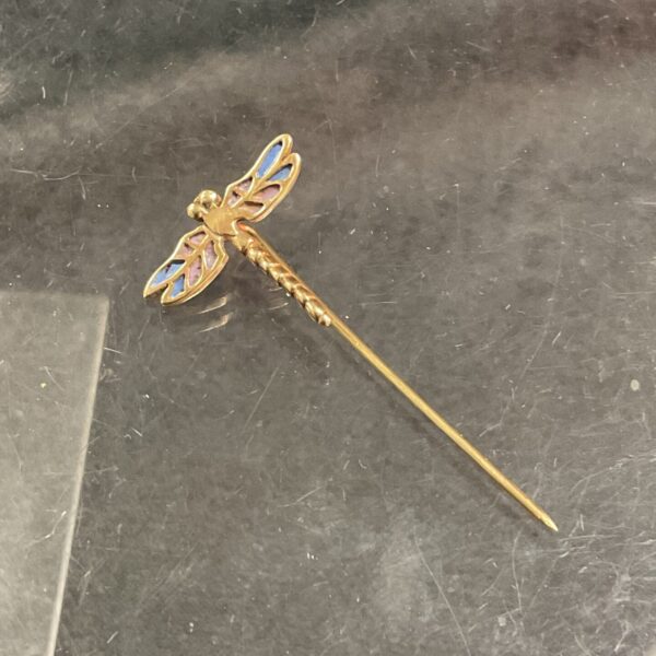 Vintage yellow metal dragonfly tie pin with enameled wings.