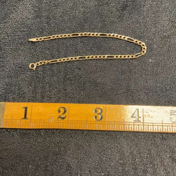 Delicate 9ct gold Figaro bracelet, classic gold jewellery.