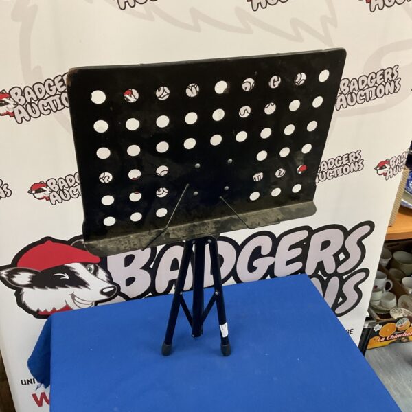 Black folding sheet music stand for musicians, angled view.