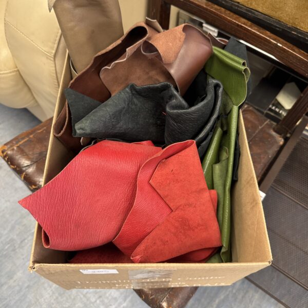 A box of colourful upholstery scraps for crafting projects.