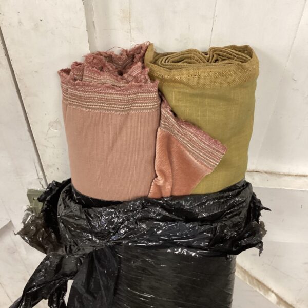 Two rolls of fabric one green & one pink