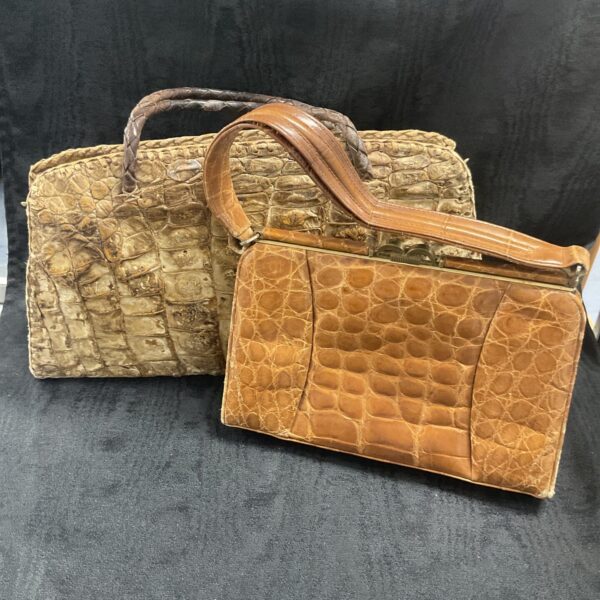 Pair of vintage crocodile skin handbags with structured designs.