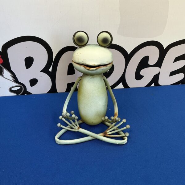 Whimsical metal frog sculpture for garden or home decor.