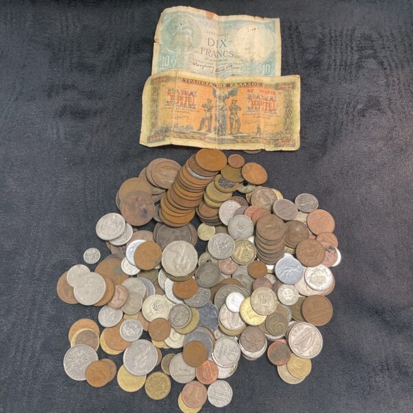 Assorted coin lot with French banknotes, vintage currency collection.