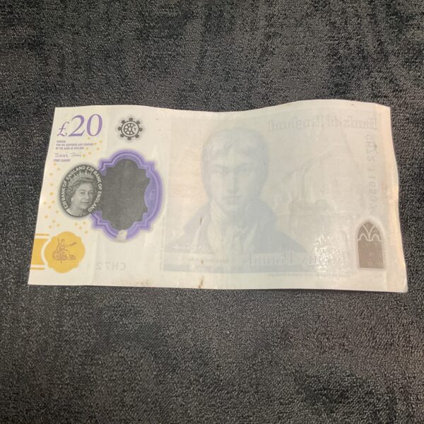 Front view of a misprinted twenty pound note with distorted design.