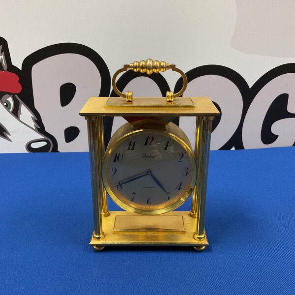 Vintage Imhof Bucherer carriage clock with brass case and white dial.