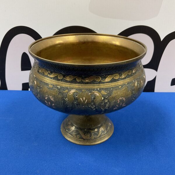 Intricately engraved Indian brass bowl with floral designs.