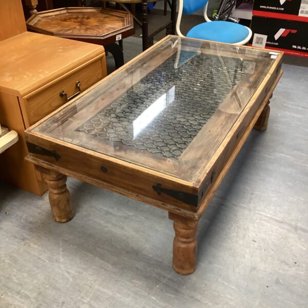 Intricate Indian coffee table with a glass top and inlaid wood detail.