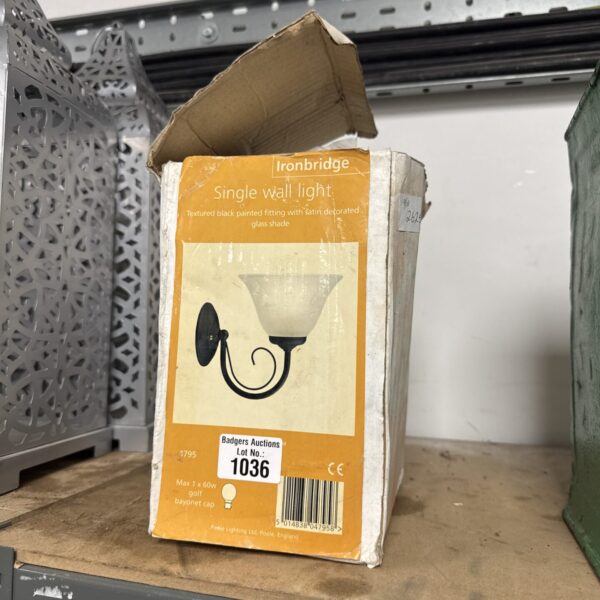 Black Iron bridge wall light with satin glass shade.