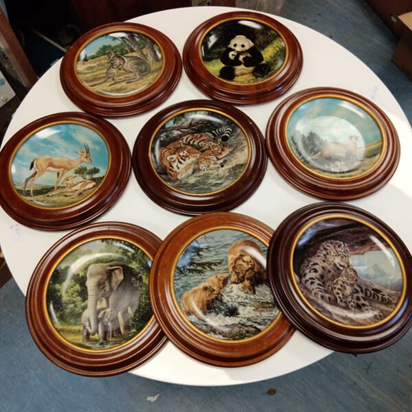 Set of J George collectors plates featuring various animal designs.