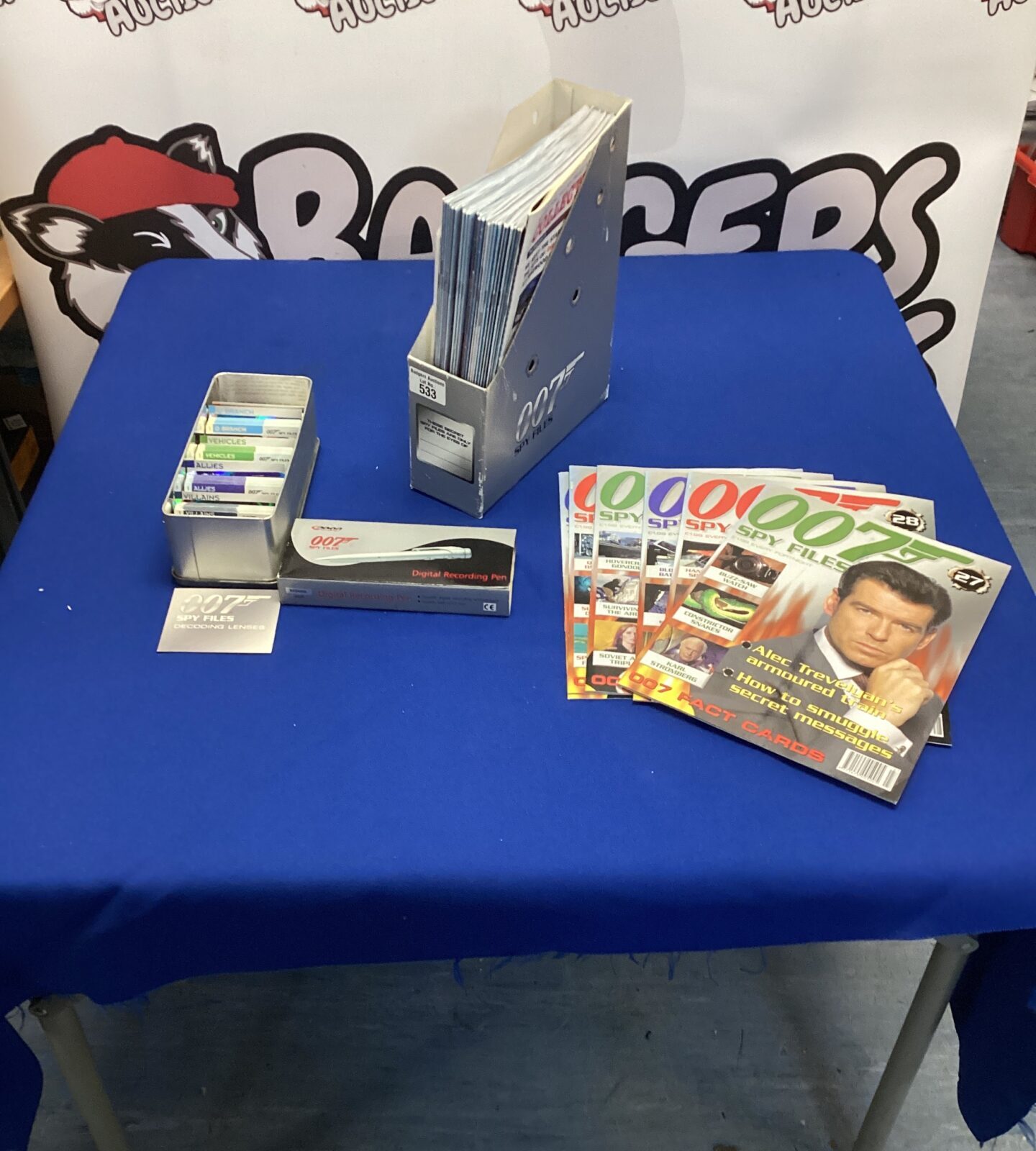 James Bond memorabilia bundle with spy pen and playing cards.