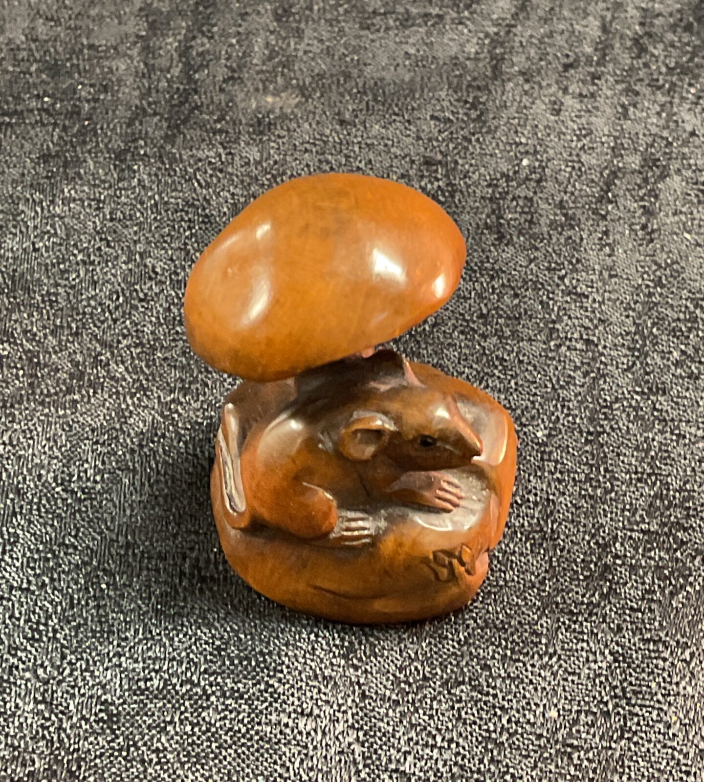 Vintage Japanese netsuke carving of a mouse on a mushroom.