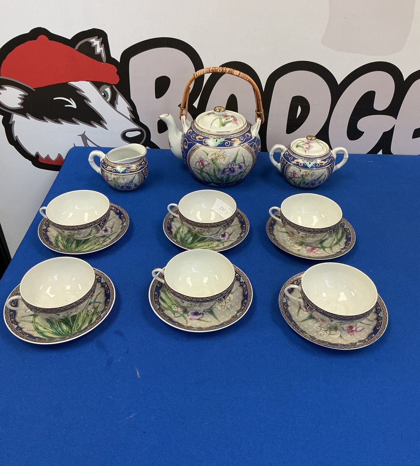 Vintage Japanese porcelain tea set with floral designs.
