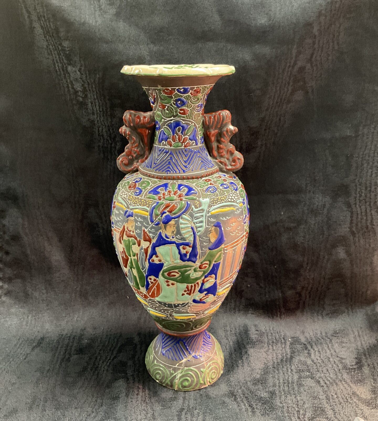 Side view of antique Japanese Satsuma vase with detailed patterns.