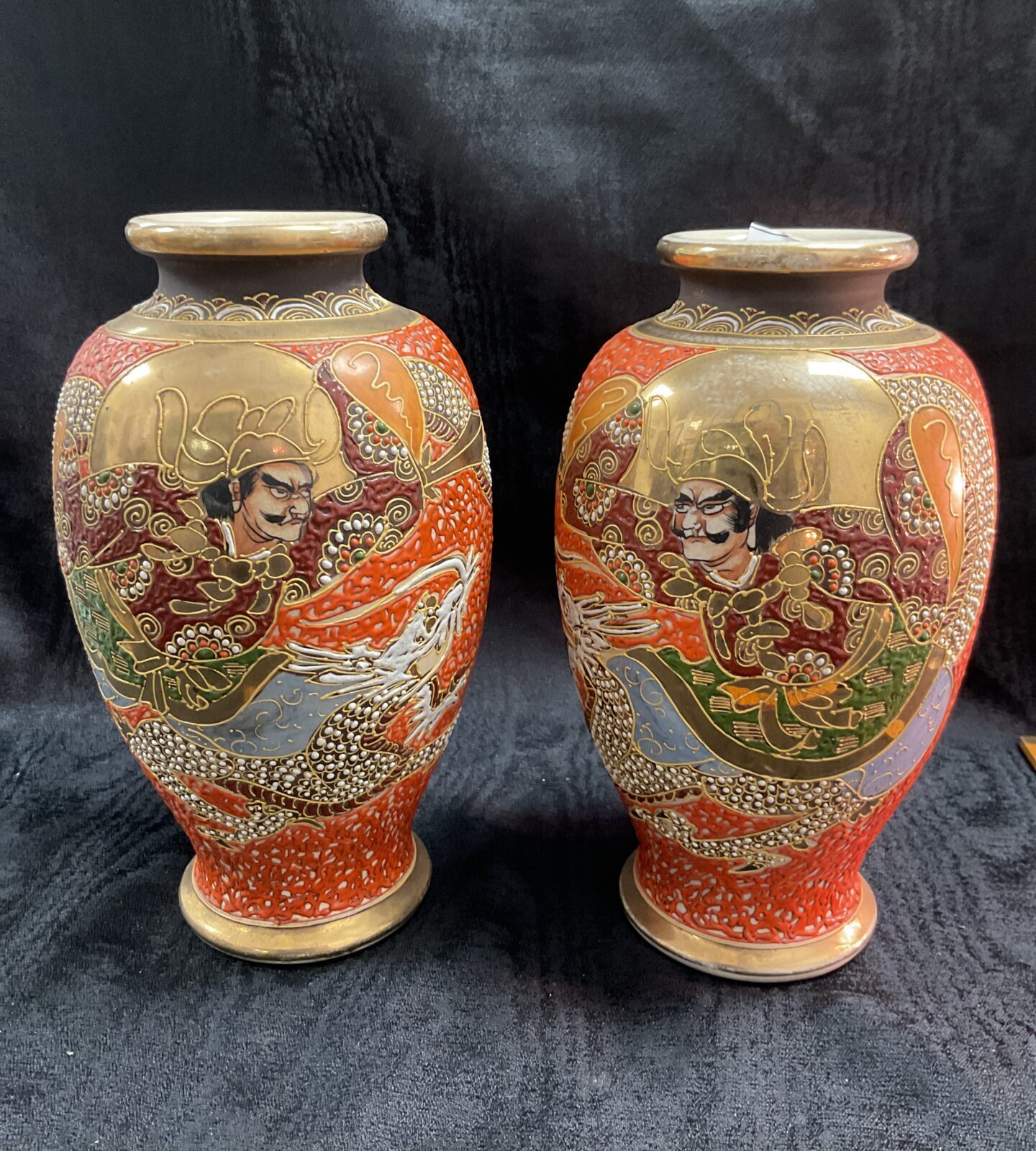Pair of antique Japanese Satsuma vases with detailed artwork.