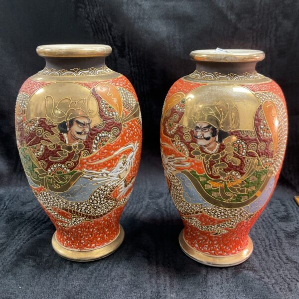 Pair of antique Japanese Satsuma vases with detailed artwork.