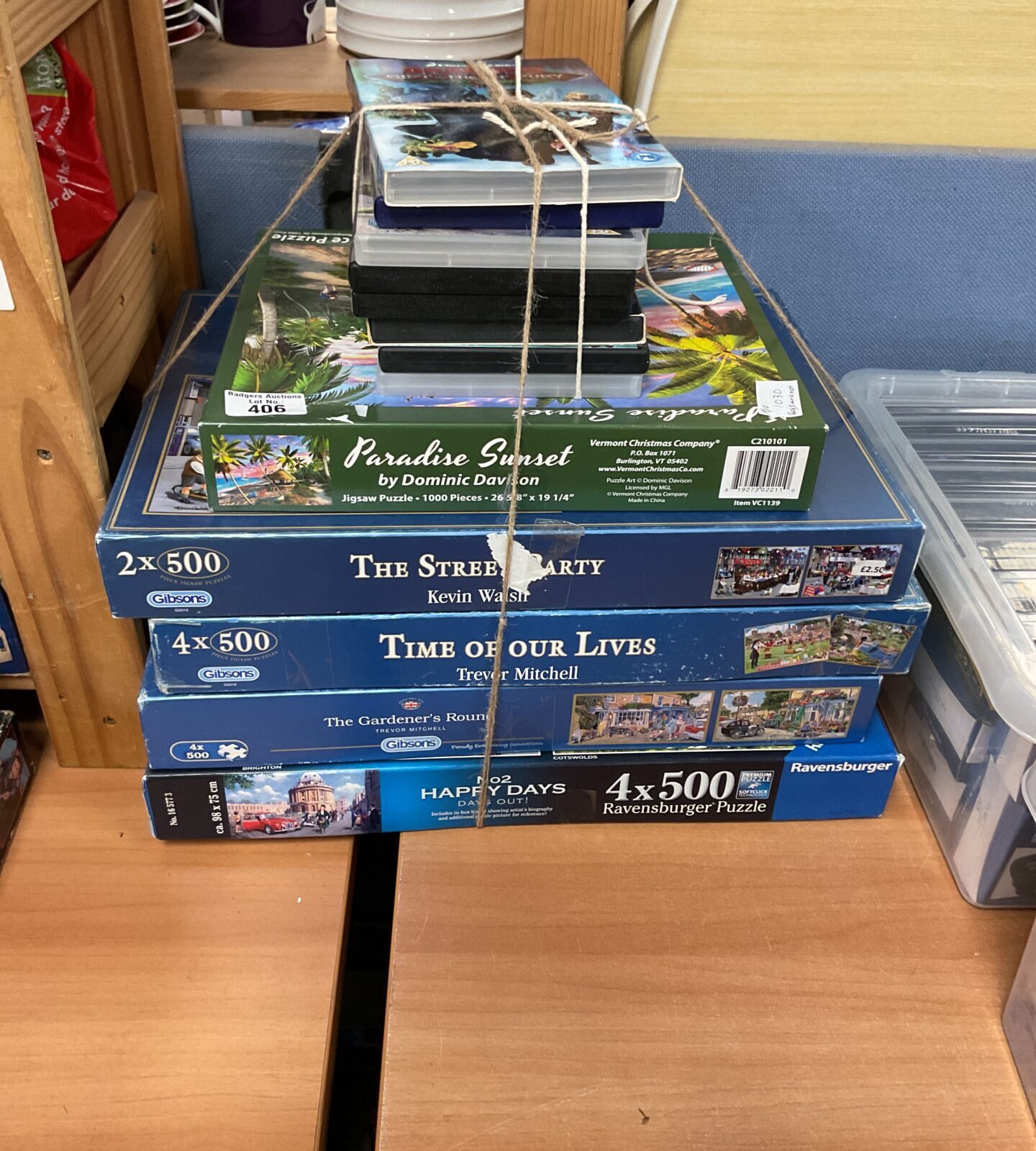 Mixed lot of jigsaw puzzles and DVDs for family entertainment.